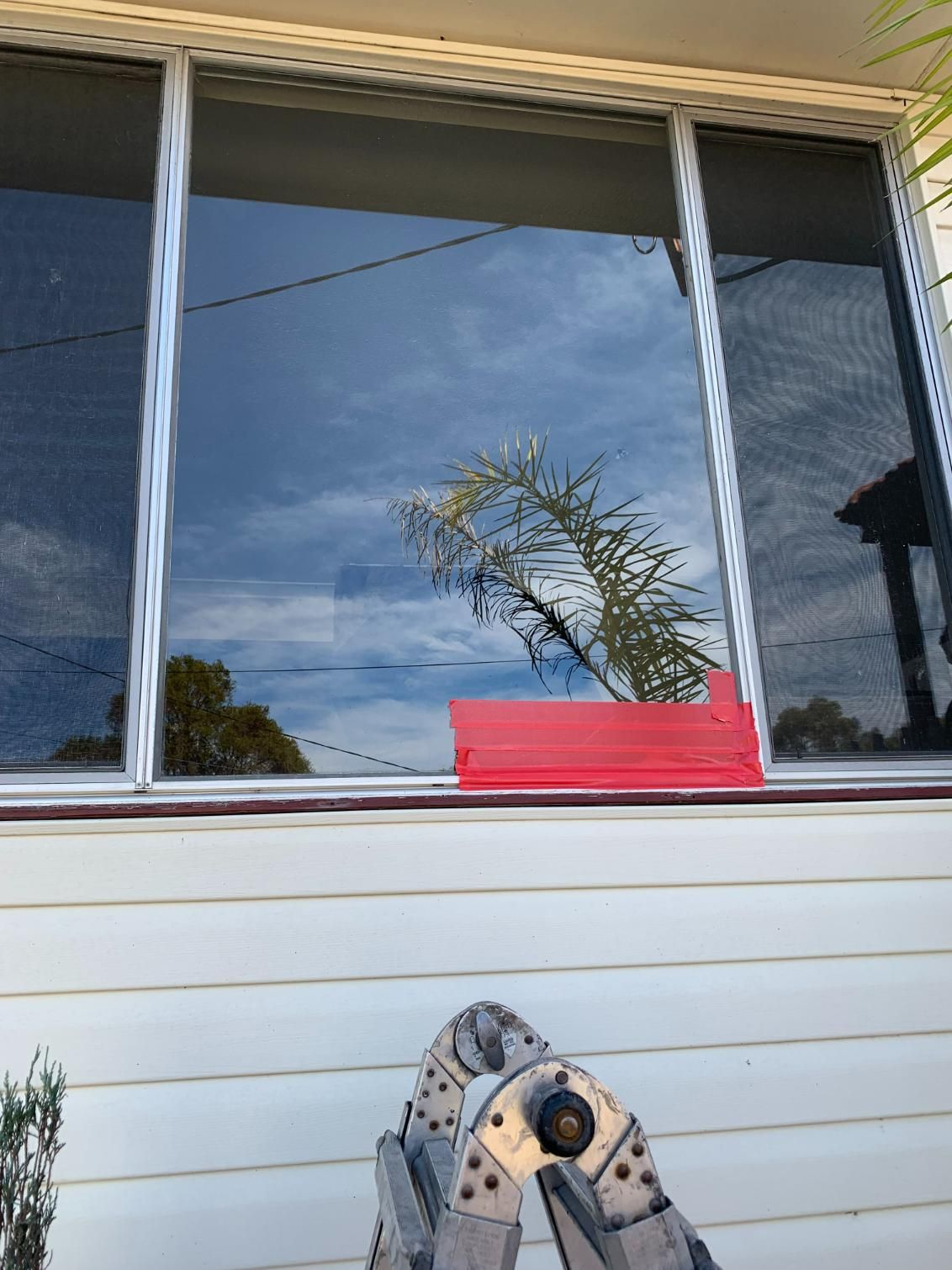 A Ladder Is Sitting In Front Of A Window On A House — Central Coast Glass & Glazing In Umina Beach, NSW