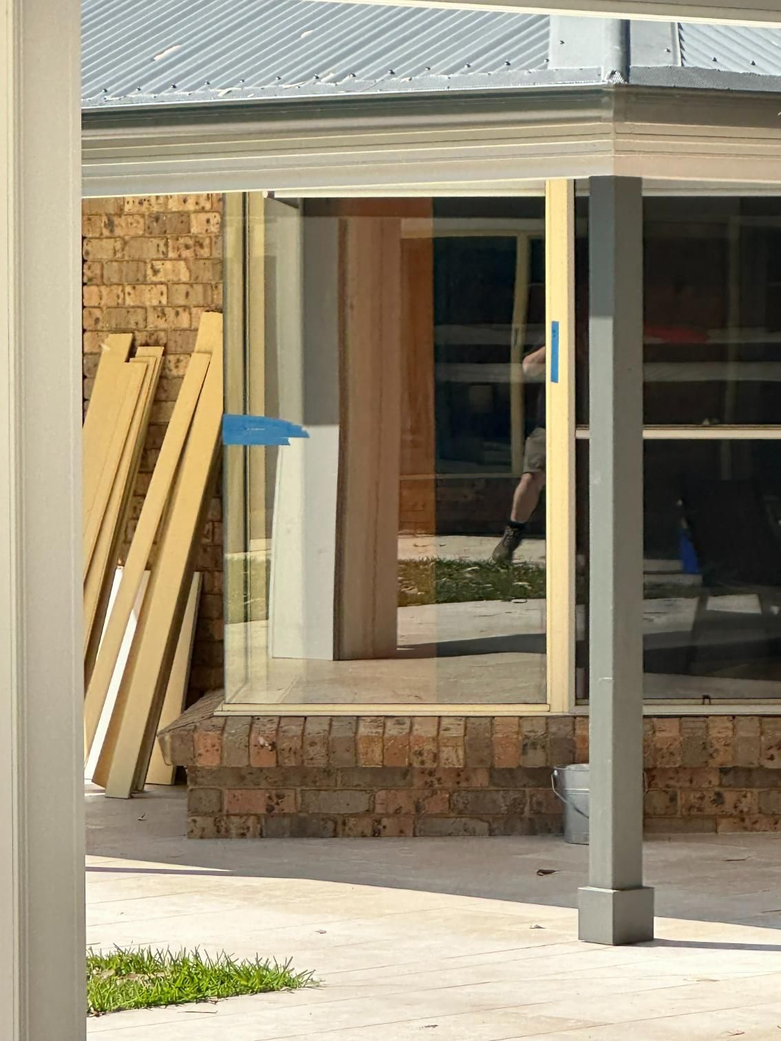 A House Under Construction With A Blue Tape On The Door — Central Coast Glass & Glazing In Umina Beach, NSW