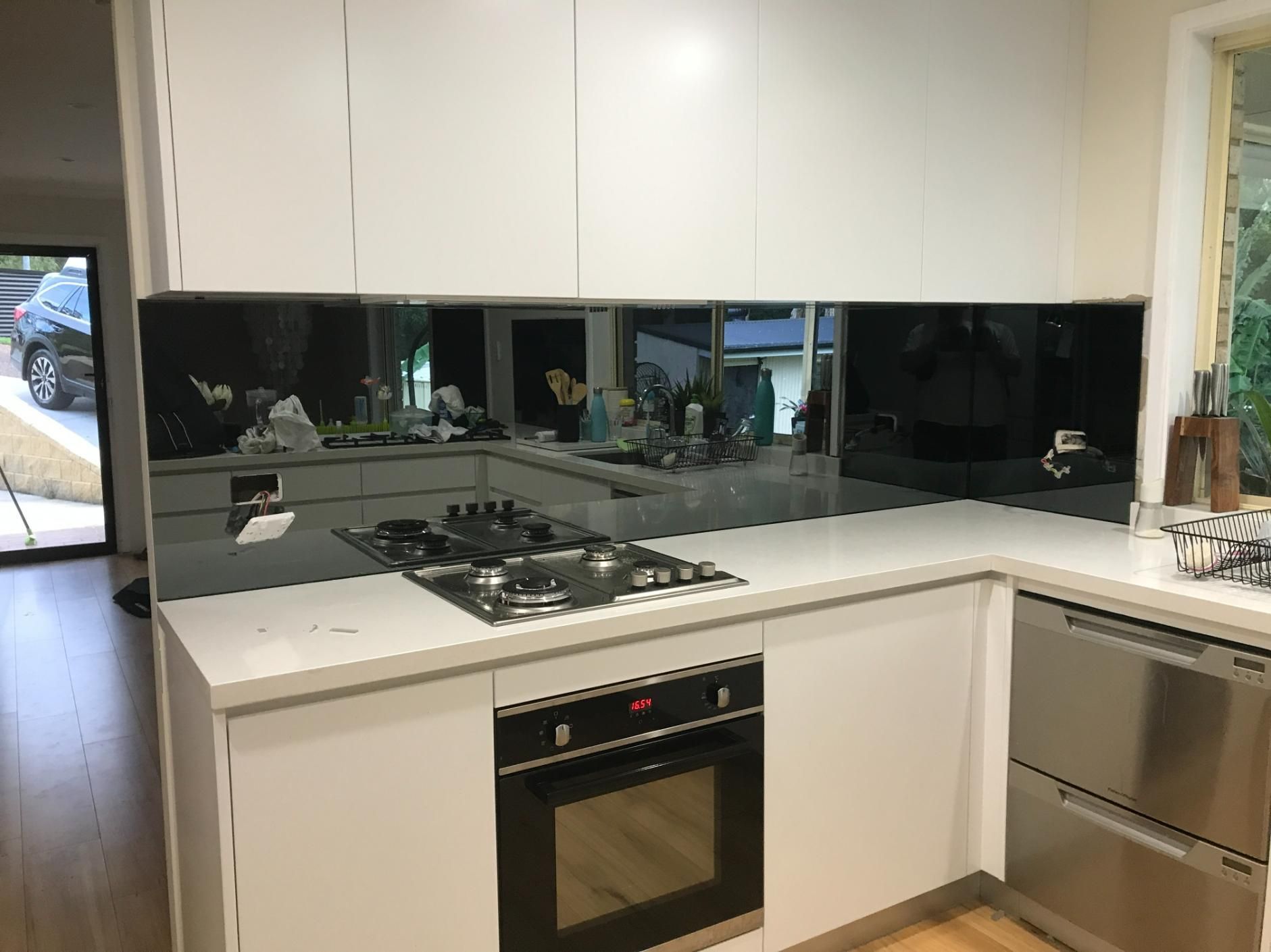 A Kitchen With White Cabinets, Stainless Steel Appliances — Central Coast Glass & Glazing In Umina Beach, NSW