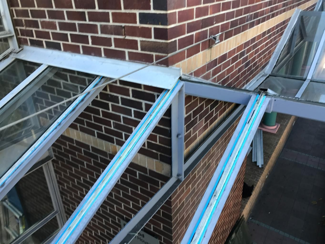 A Brick Building With A Glass Roof On The Side — Central Coast Glass & Glazing In Umina Beach, NSW
