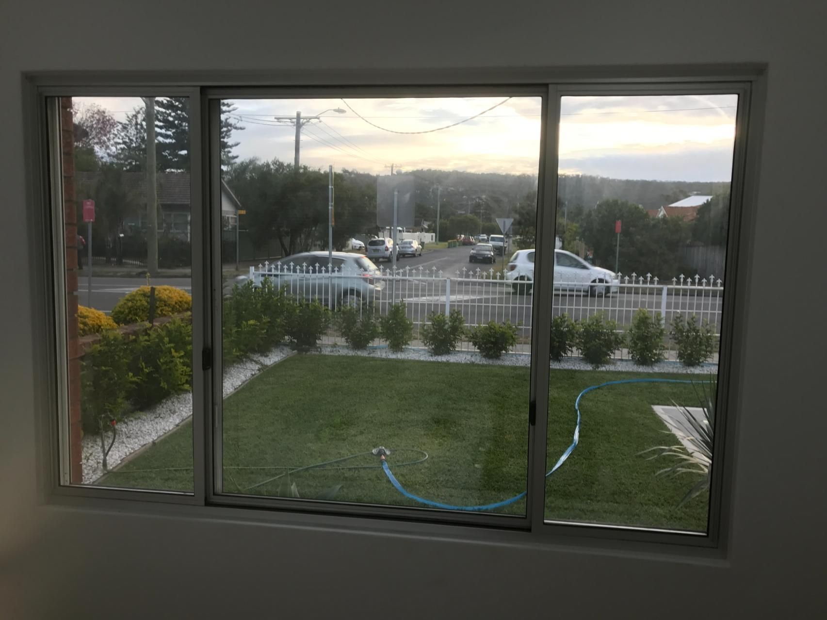 A Large Window With A View Of A Yard And A Street — Central Coast Glass & Glazing In Umina Beach, NSW