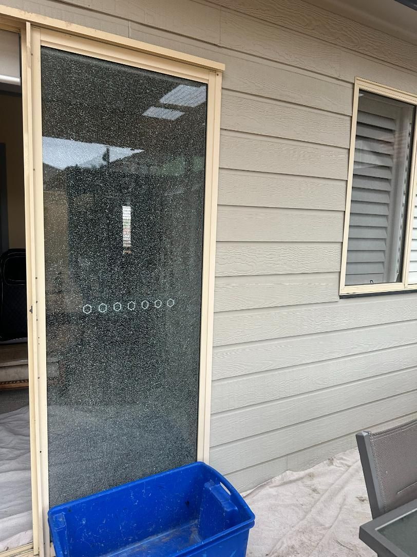 A Blue Box Is Sitting In Front Of A Sliding Glass Door — Central Coast Glass & Glazing In The Entrance, NSW