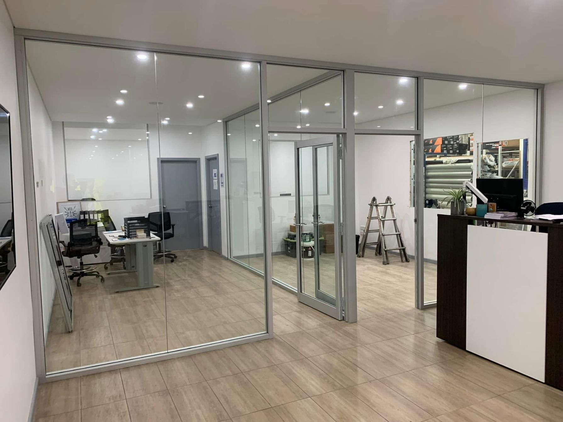 A Large Office With A Lot Of Glass Walls And Doors — Central Coast Glass & Glazing In Umina Beach, NSW