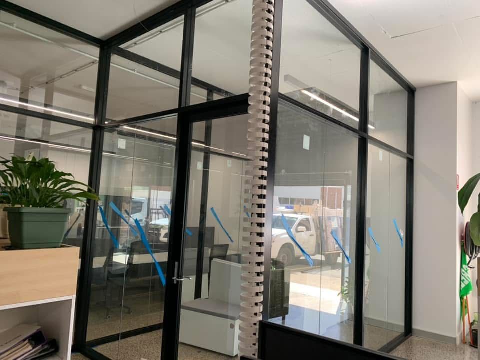 A Room With A Lot Of Windows And A Couch In It — Central Coast Glass & Glazing In Umina Beach, NSW
