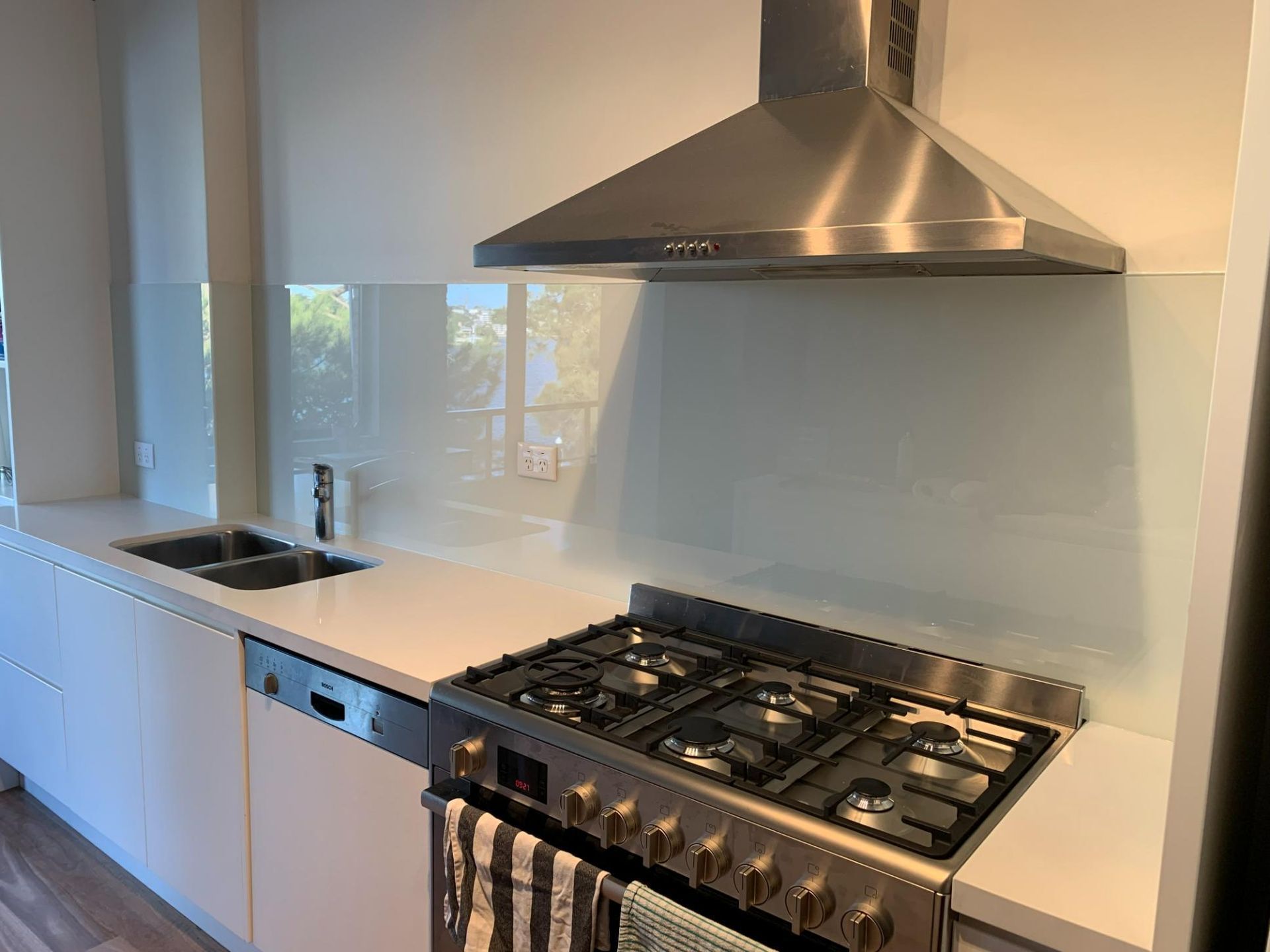A Kitchen With A Stove, Sink, And Dishwasher — Central Coast Glass & Glazing In Umina Beach, NSW