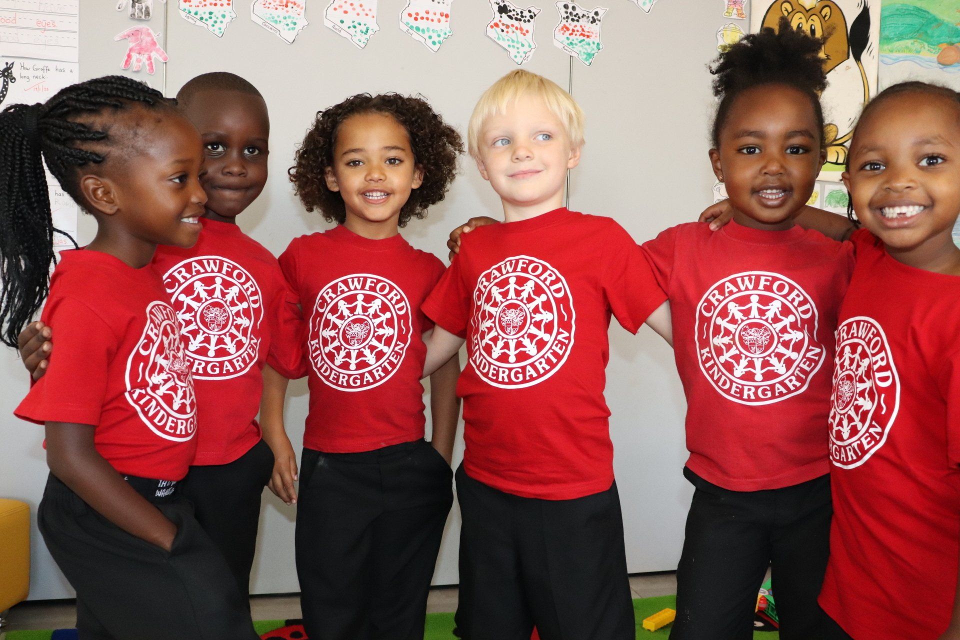a group of children wearing red crawford shirts 