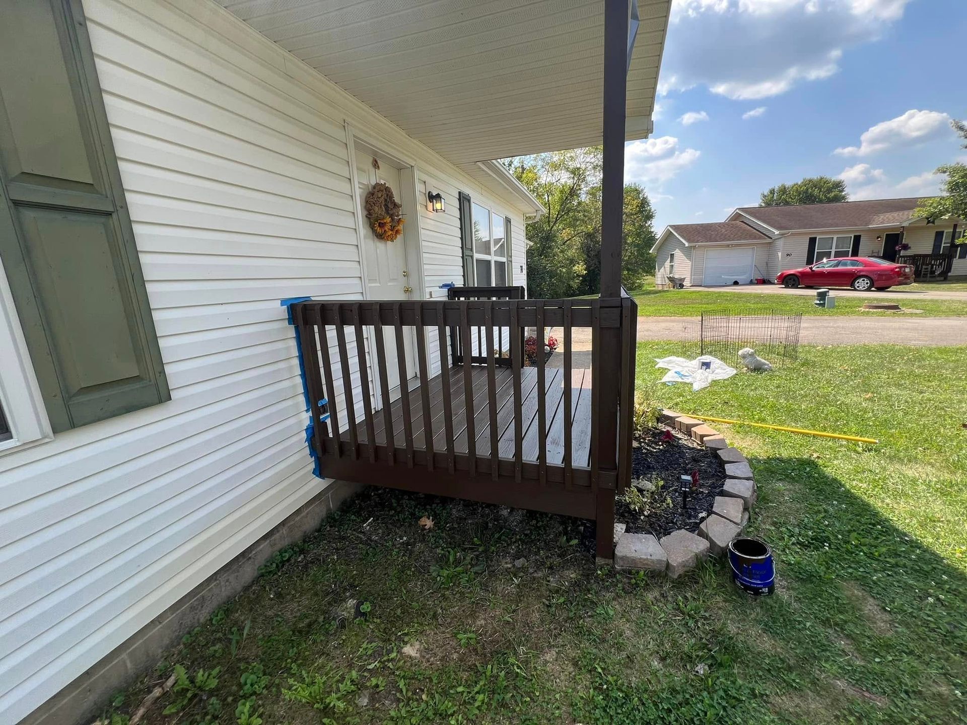 A house with a porch that is being painted.