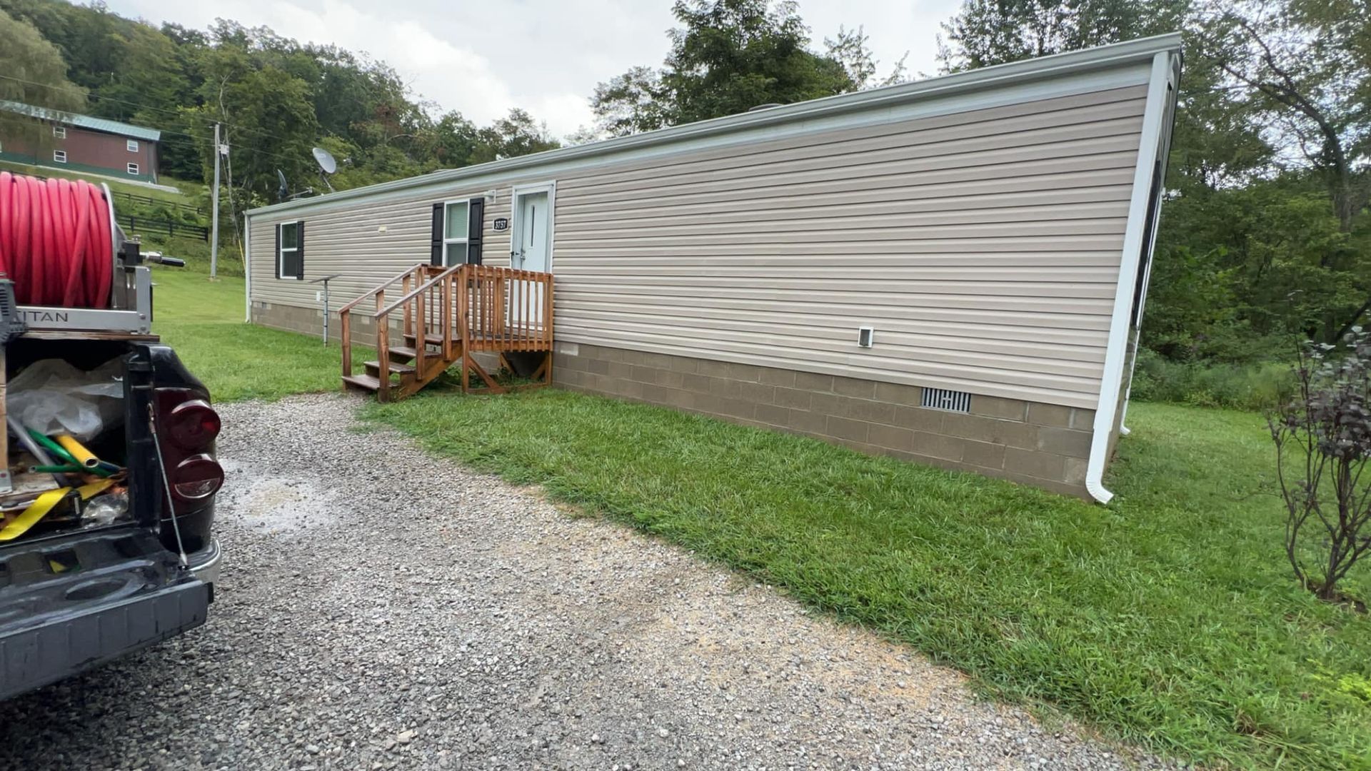A truck is parked in front of a mobile home.