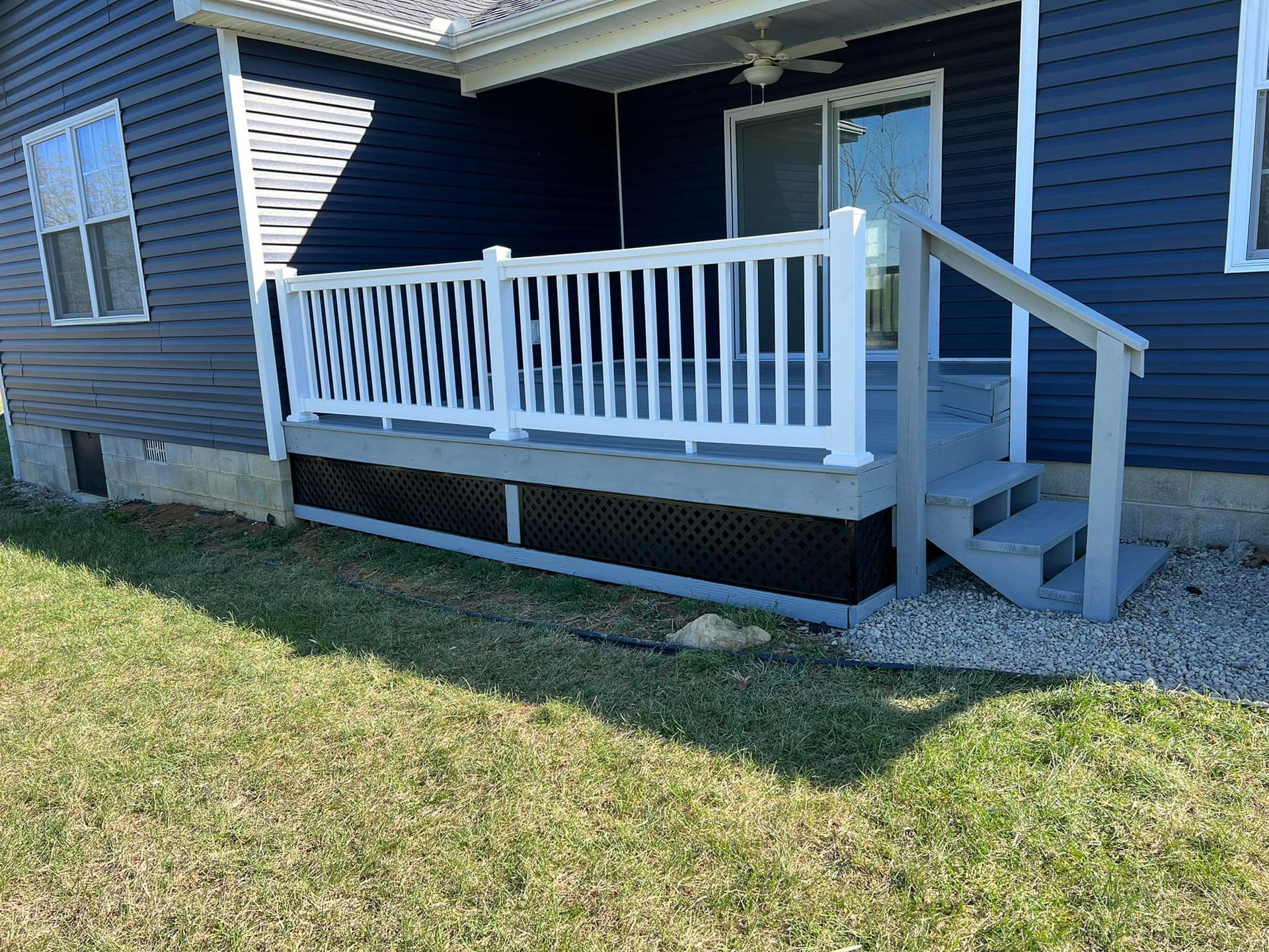 A blue house with a white porch and stairs.