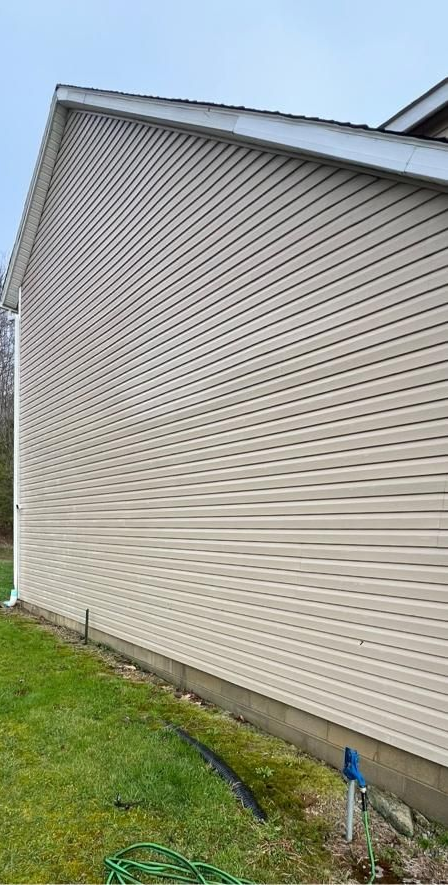 A long porch with a wooden table and a white ceiling.