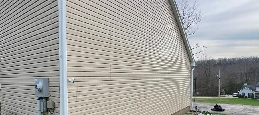 A window on the side of a house with a glass block window.