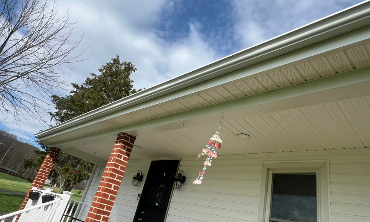 A window on the side of a house with a glass block window.