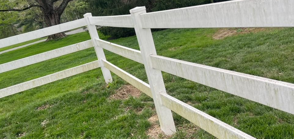 A porch with a wooden table and shutters on a house.