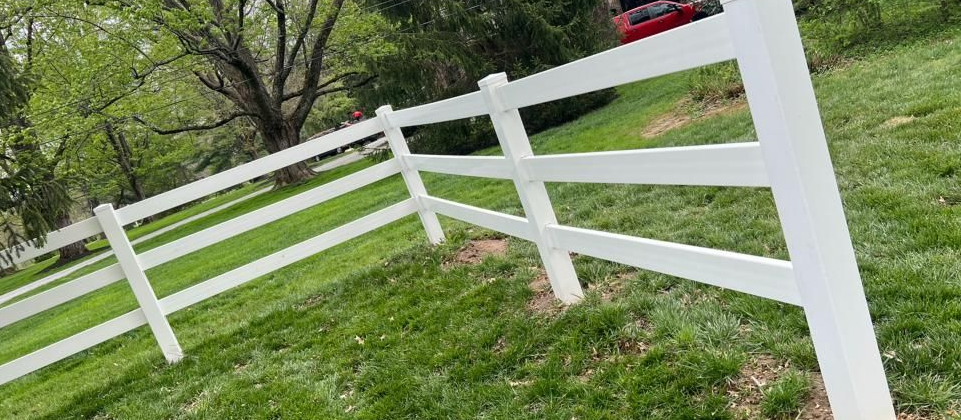 A long porch with a wooden table and a white ceiling.