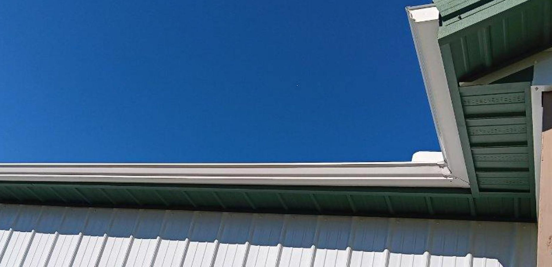 A window on the side of a house with a glass block window.