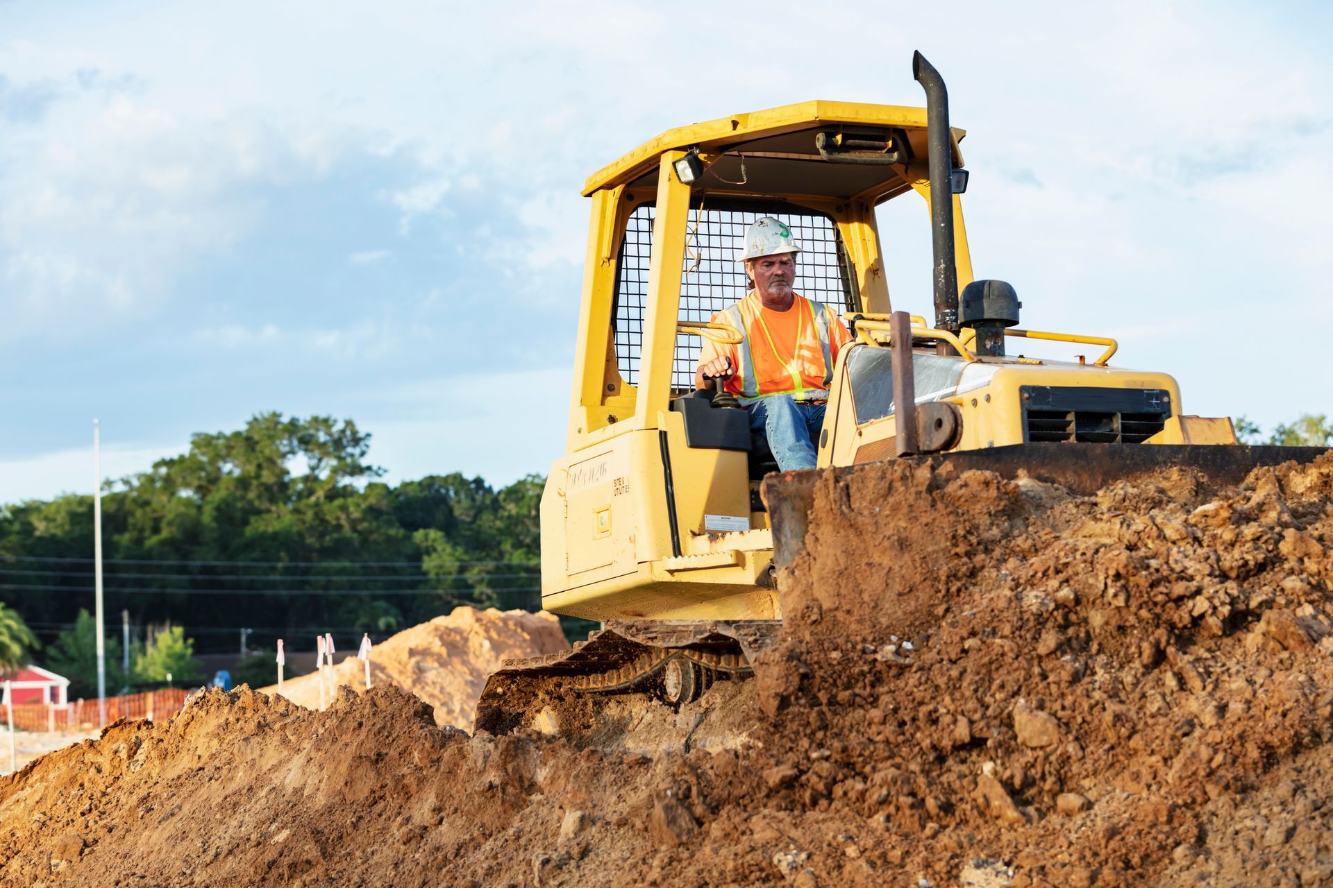A bulldozer is digging in the mud on a construction site. A bulldozer is digging in the mud on a construction site.