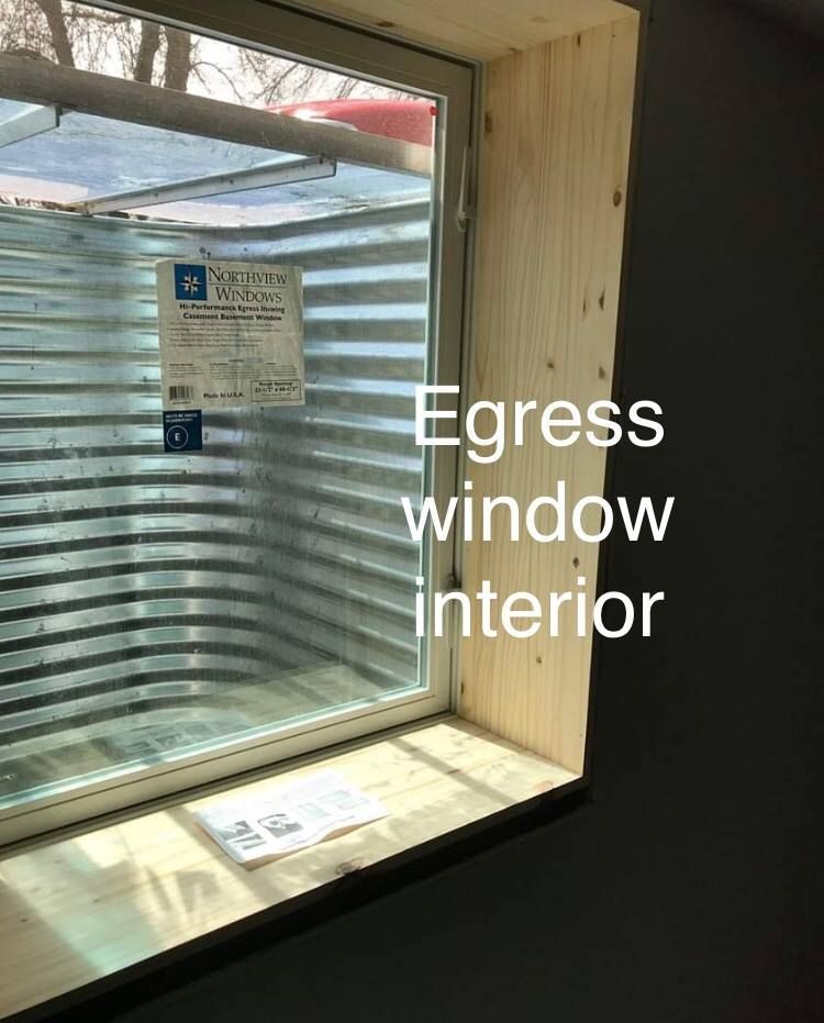 A window in a room with the words egress window interior written on it.
