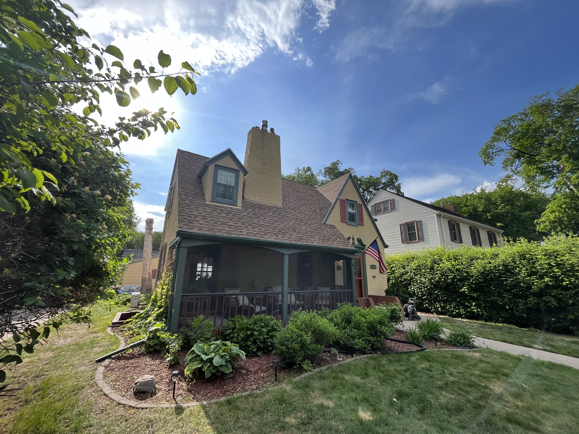 A house with a porch and a chimney on top of it