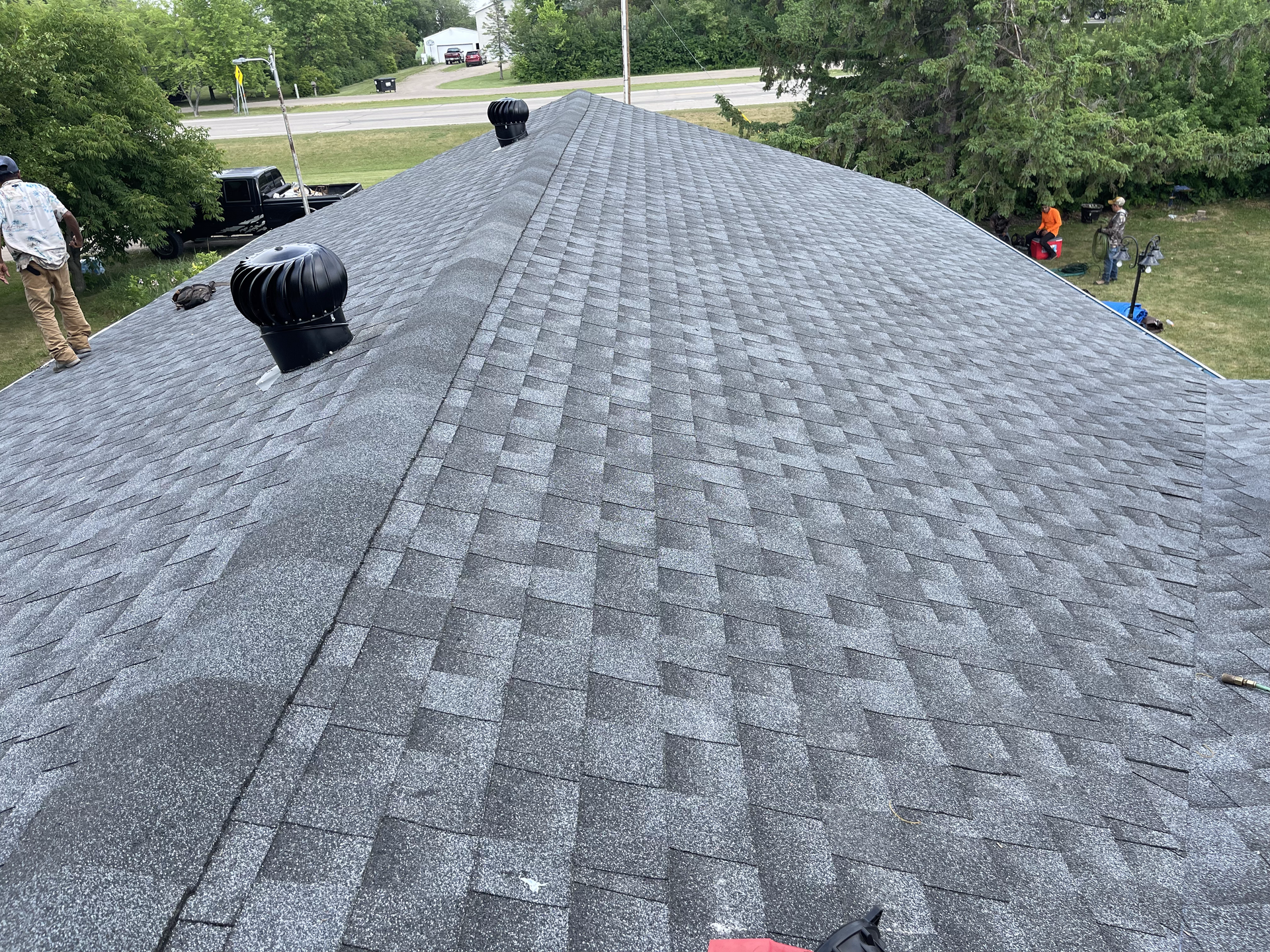 A man is working on the roof of a house.