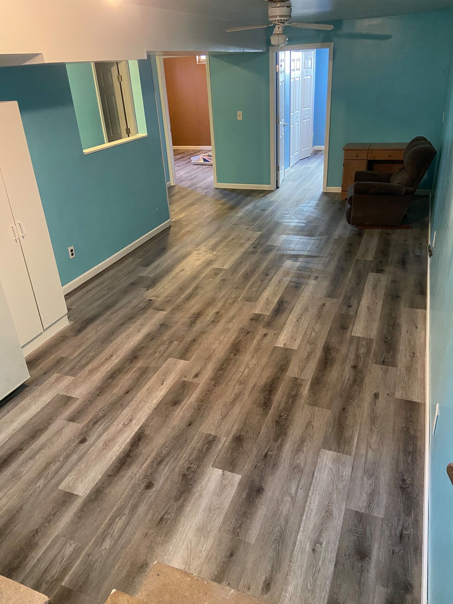 A living room with hardwood floors and blue walls.