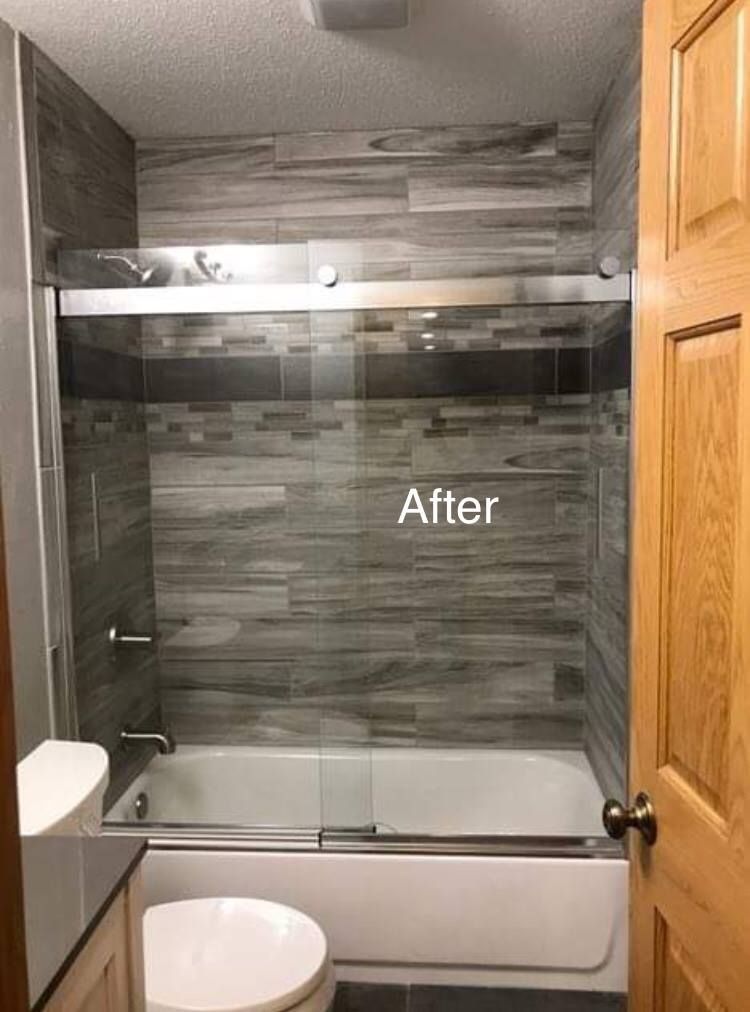 A bathroom with a bathtub , toilet , sink and shower.