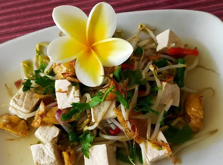 A plate of food with a flower on top of it