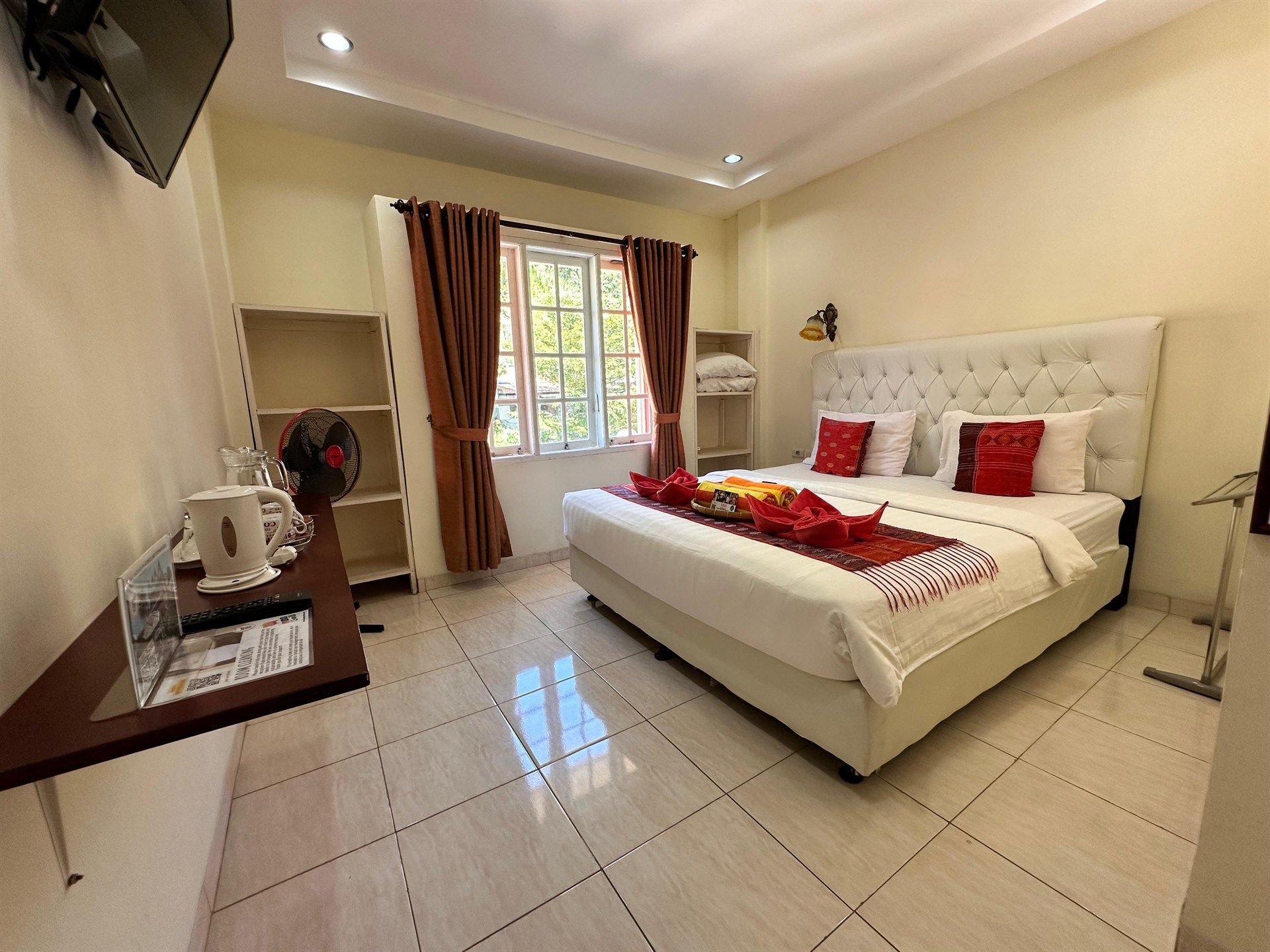 A hotel room with a large bed and a television.