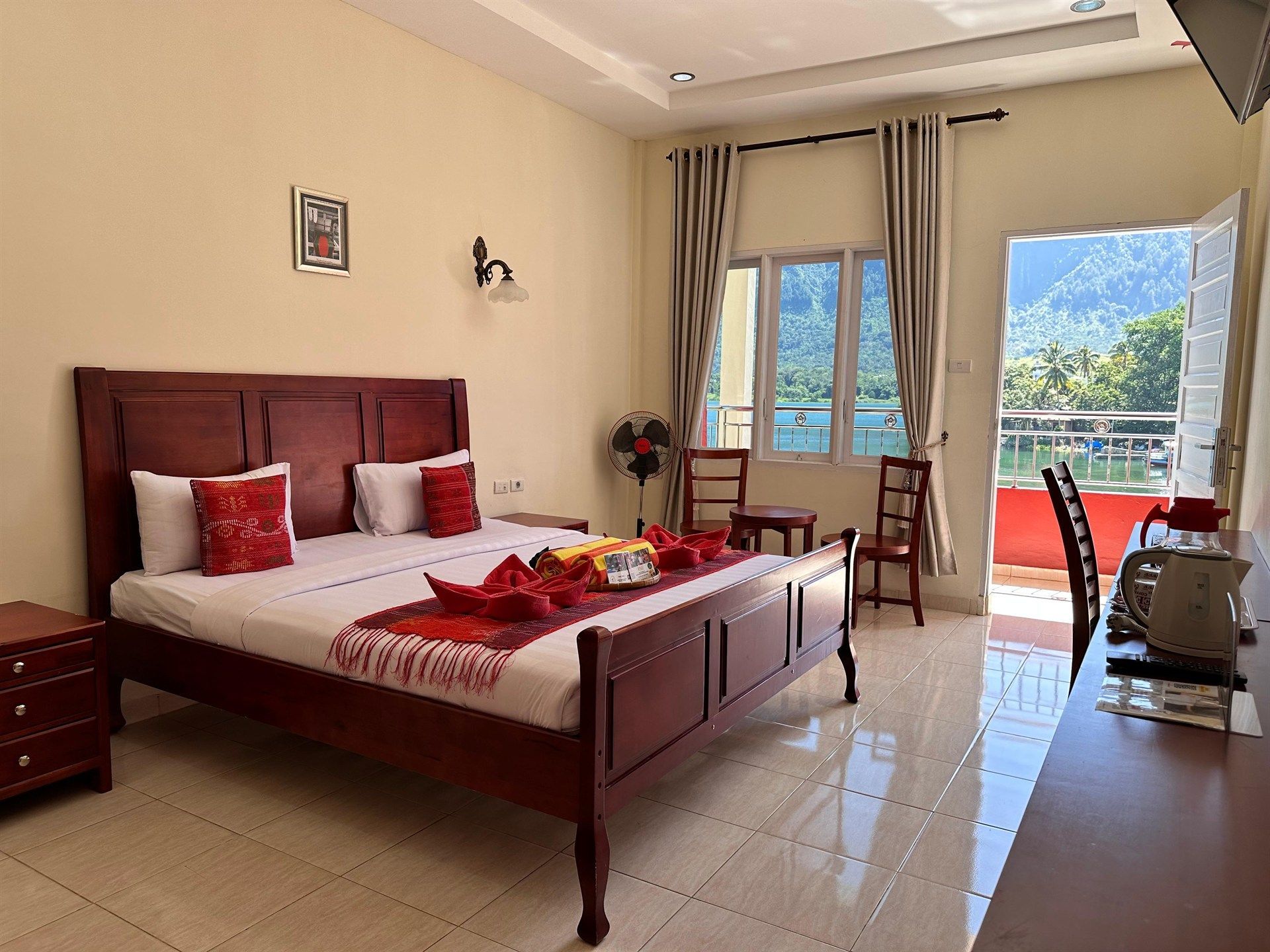 A hotel room with a large bed and a balcony