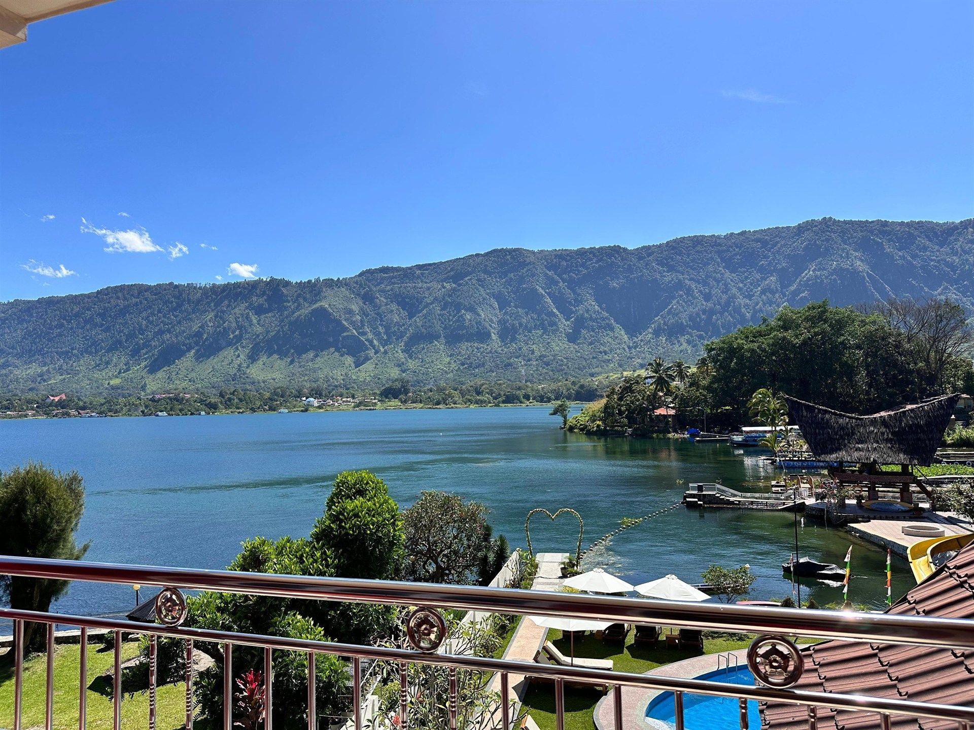 A balcony overlooking a lake with mountains in the background