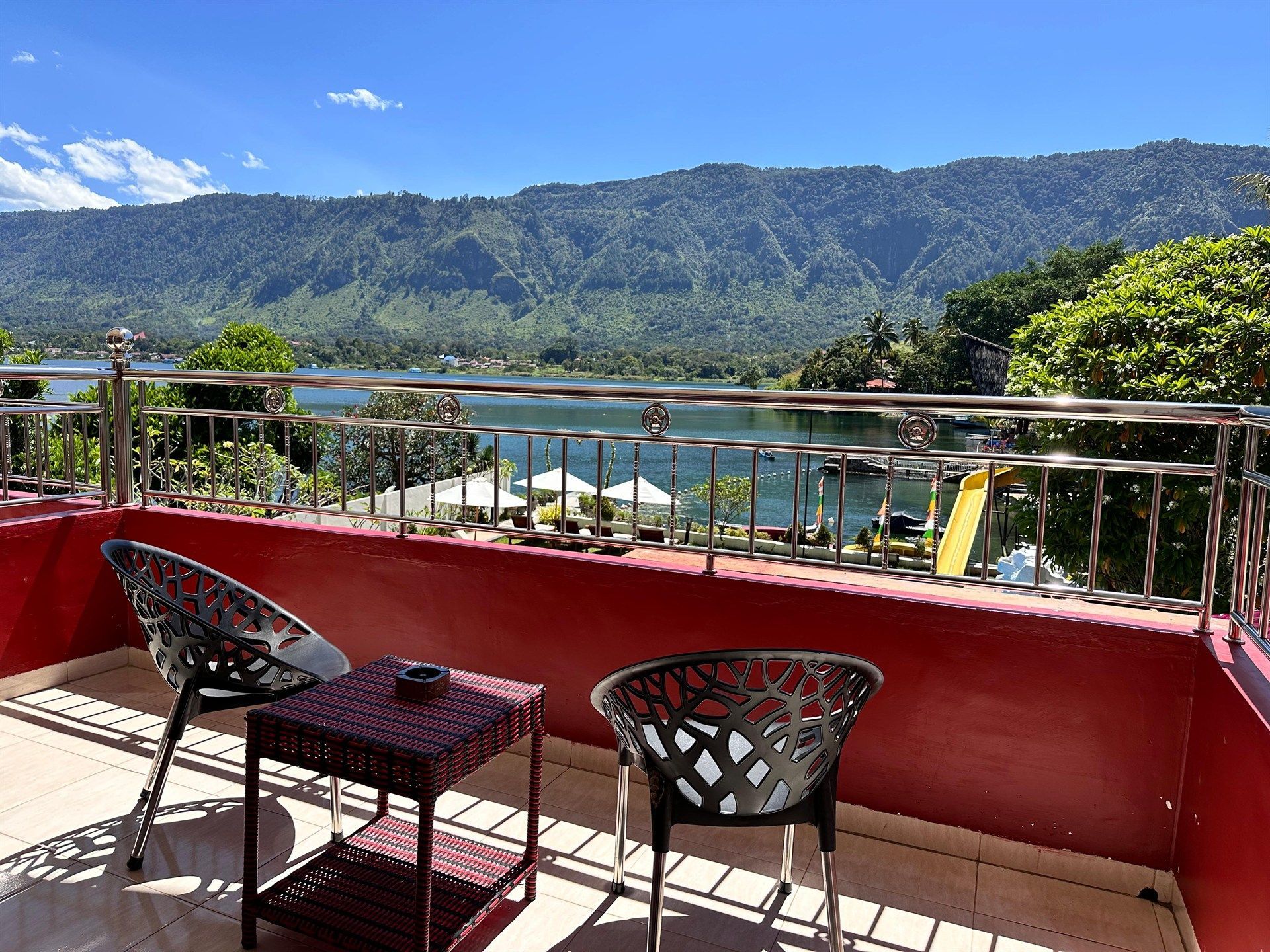 A balcony with a view of a lake and mountains.