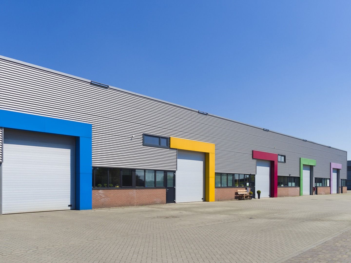 A row of colorful buildings with a blue sky in the background