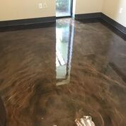 A room with a shiny metallic floor and a window.