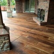 A wooden floor with a fireplace in the background.
