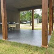 A covered patio with a sink and a wooden pillar.