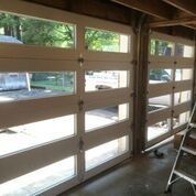 A garage door with a lot of windows and a ladder.