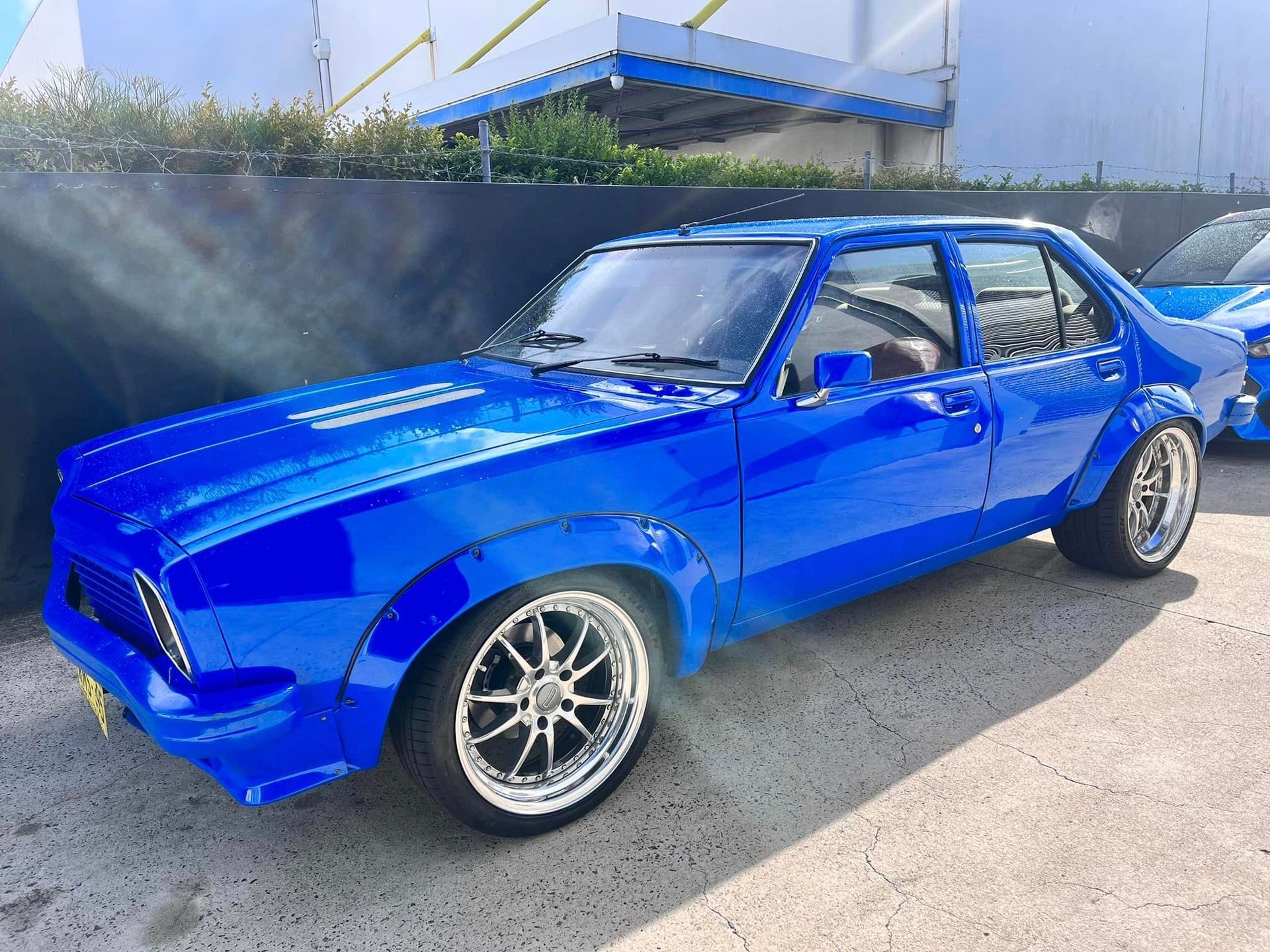 A Blue Car Is Parked in Front of A Building — Mechanic in Wollongong, NSW