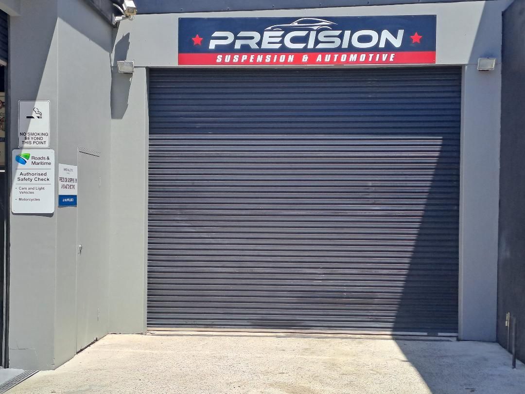 A car is Sitting on a Lift in a Garage — Mechanic in Wollongong, NSW