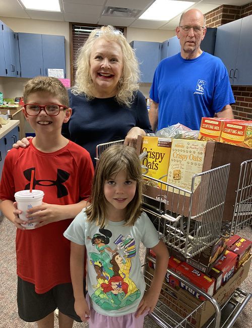 a family of four receiving food from the blessing box at St. John's Lutheran Church