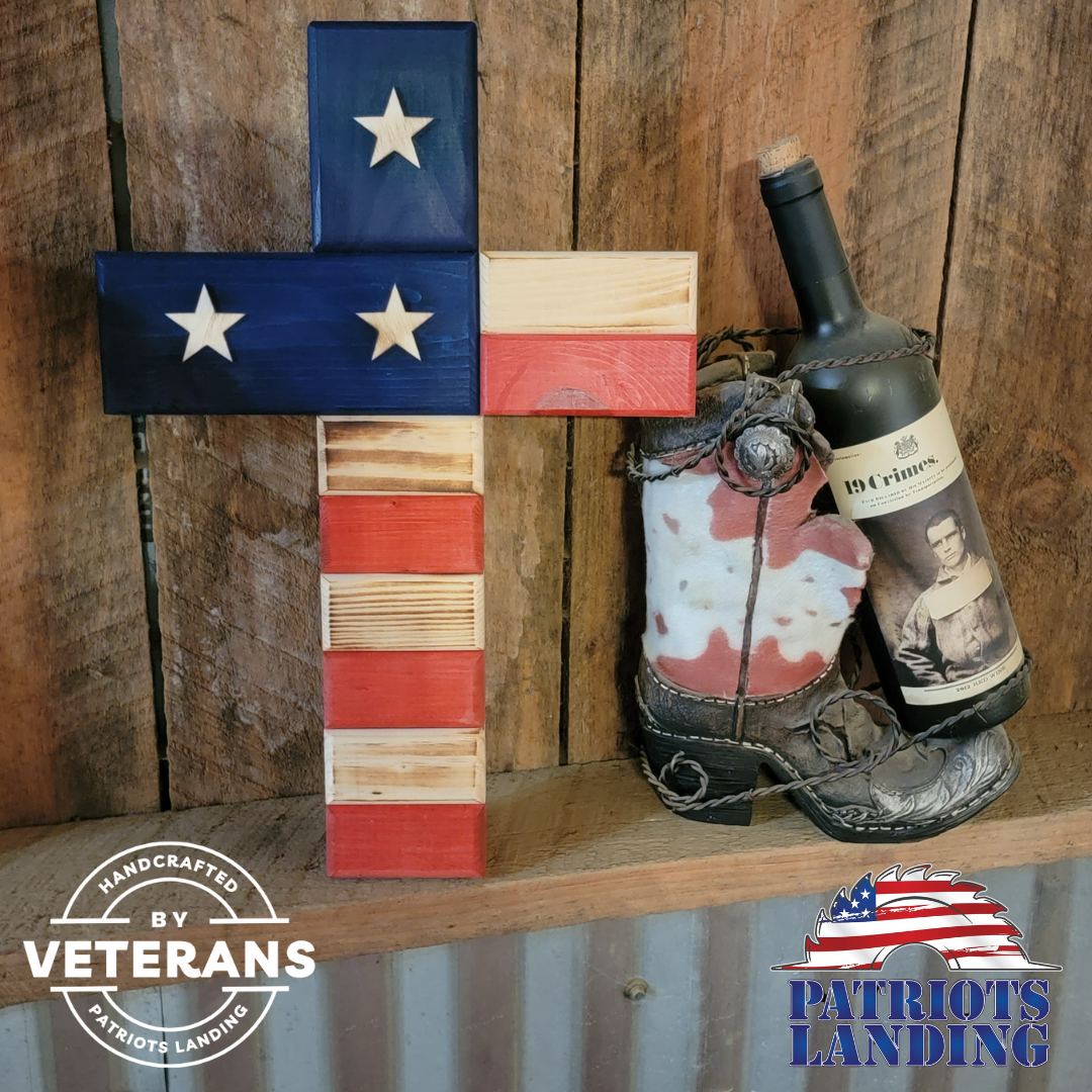 Wooden cross with painted American flag design and star accents.