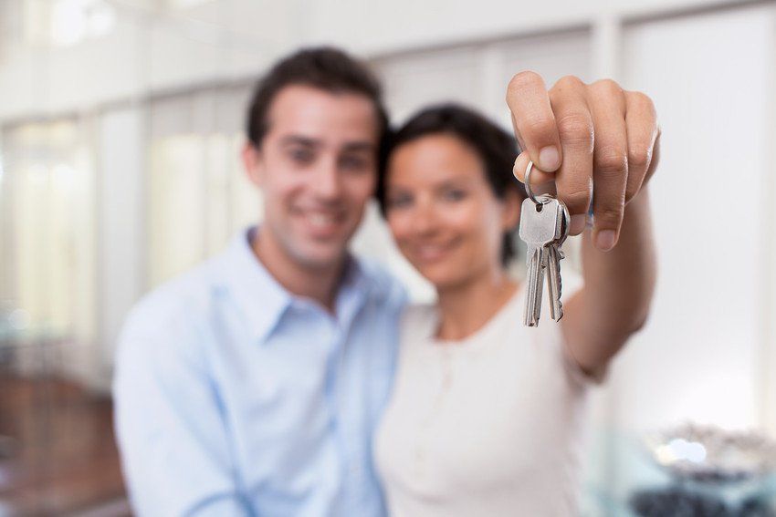 Couple with keys to first house