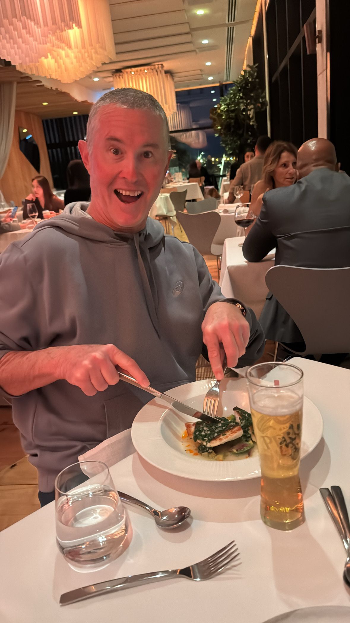 A Man is Sitting on a Boat Holding a Fish in His Hand — Mentally Hooked in Helensvale, QLD