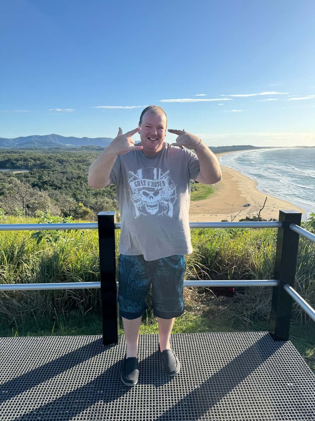 A Man is Standing on a Balcony Overlooking a Beach — Mentally Hooked in Robina, QLD