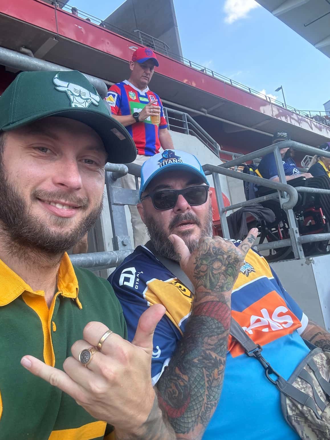 Two Men Are Standing Next to Each Other in a Stadium Giving a Thumbs Up — Mentally Hooked in Robina, QLD