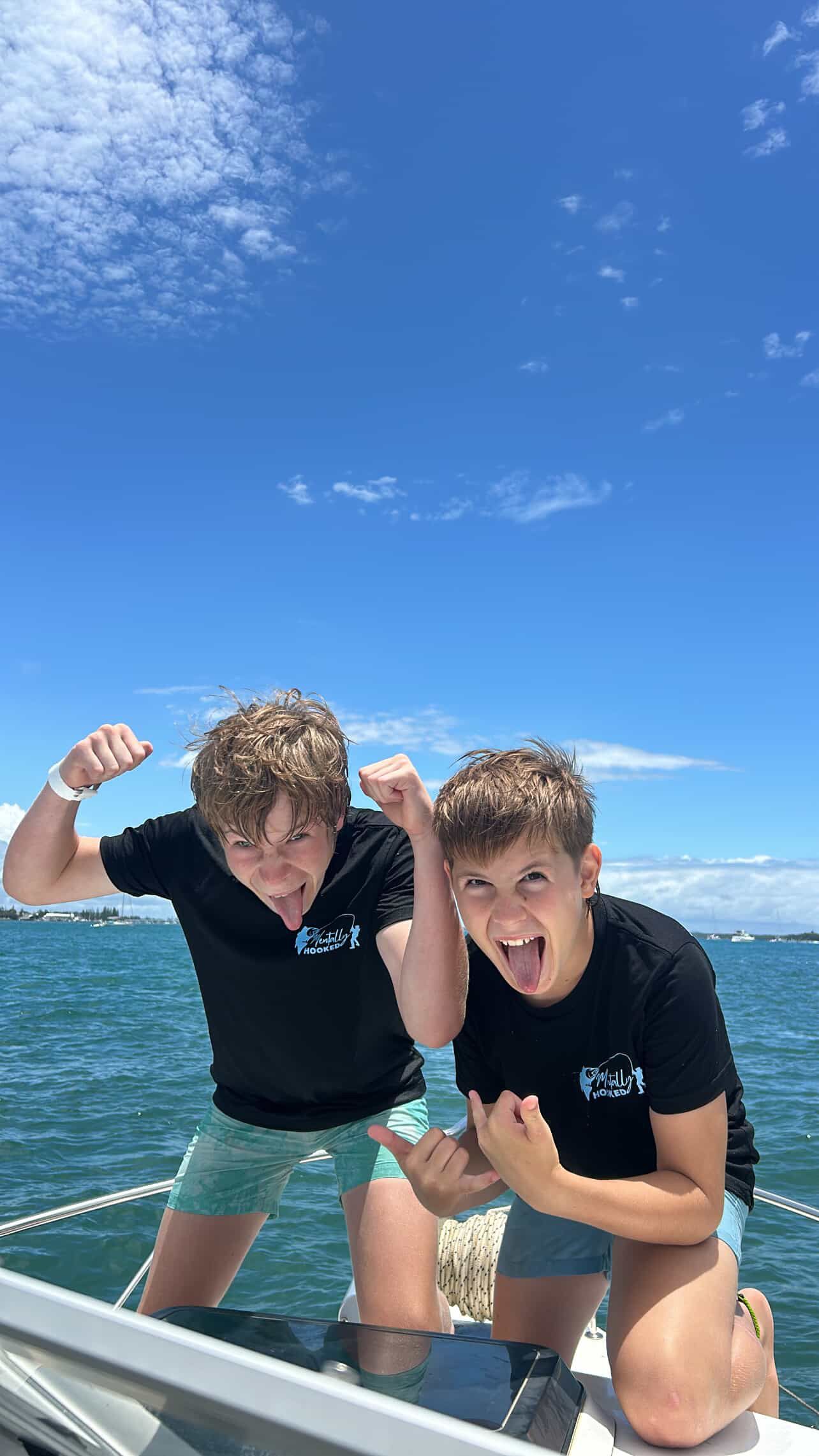 A Man is Smiling While Sitting at a Table With Plates and Glasses — Mentally Hooked in Helensvale, QLD