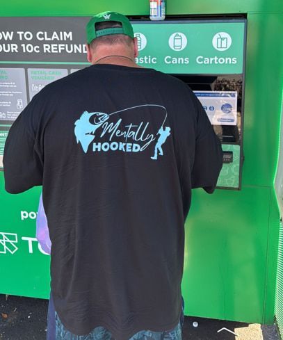 A Man is Holding a Large Fish on a Boat — Mentally Hooked in Robina, QLD