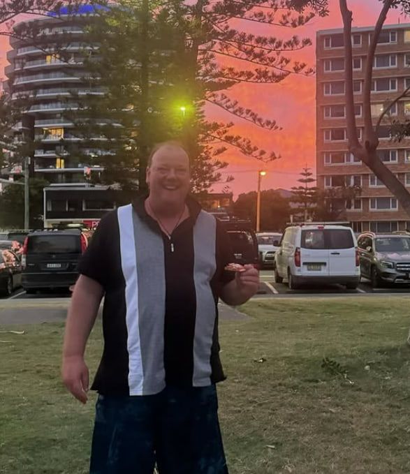A Man in a Black and White Shirt is Standing in a Parking Lot — Mentally Hooked in Robina, QLD