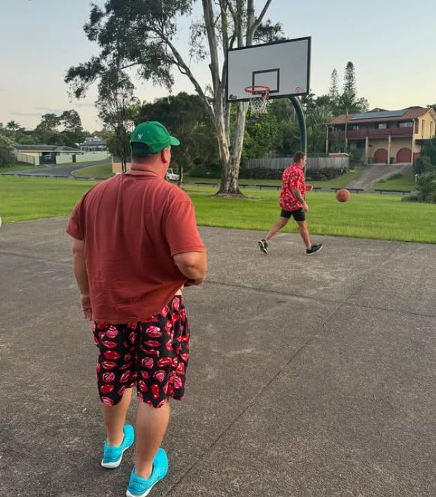 A Man in a Red Shirt is Watching Another Man Play Basketball — Mentally Hooked in Robina, QLD
