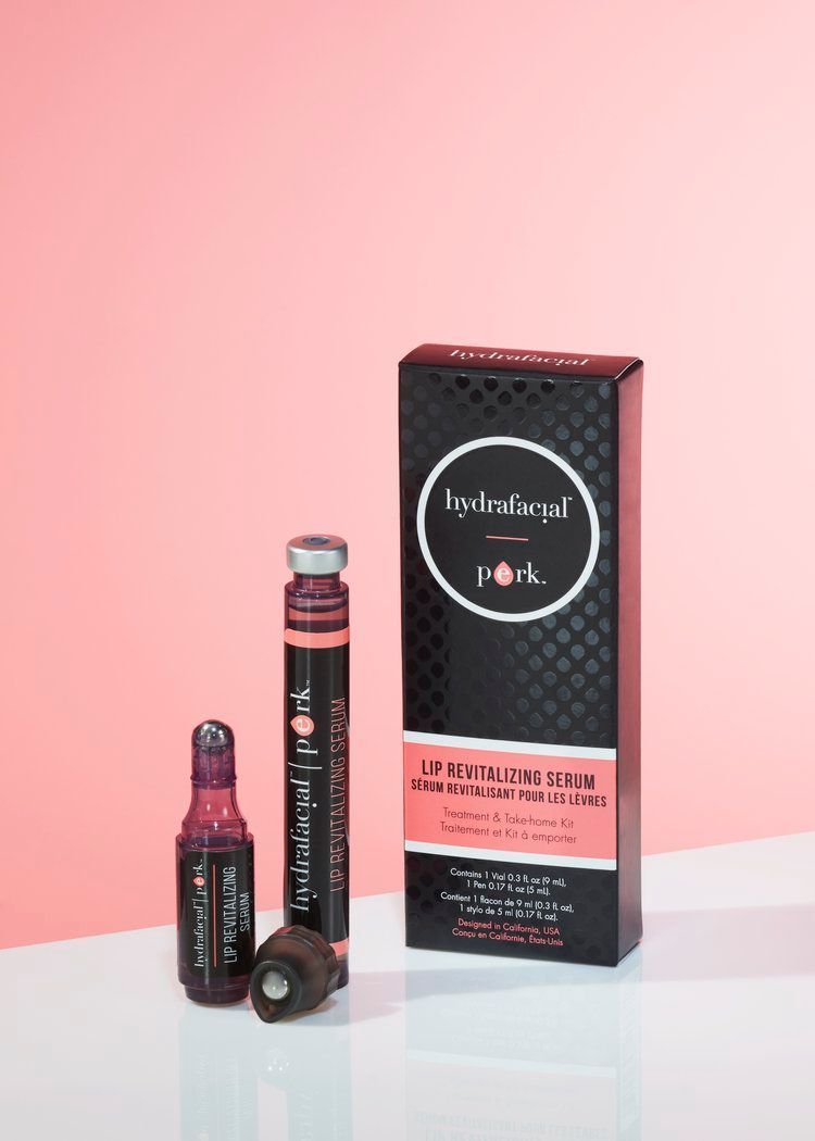 A bottle of perk lip treatment sits on a table