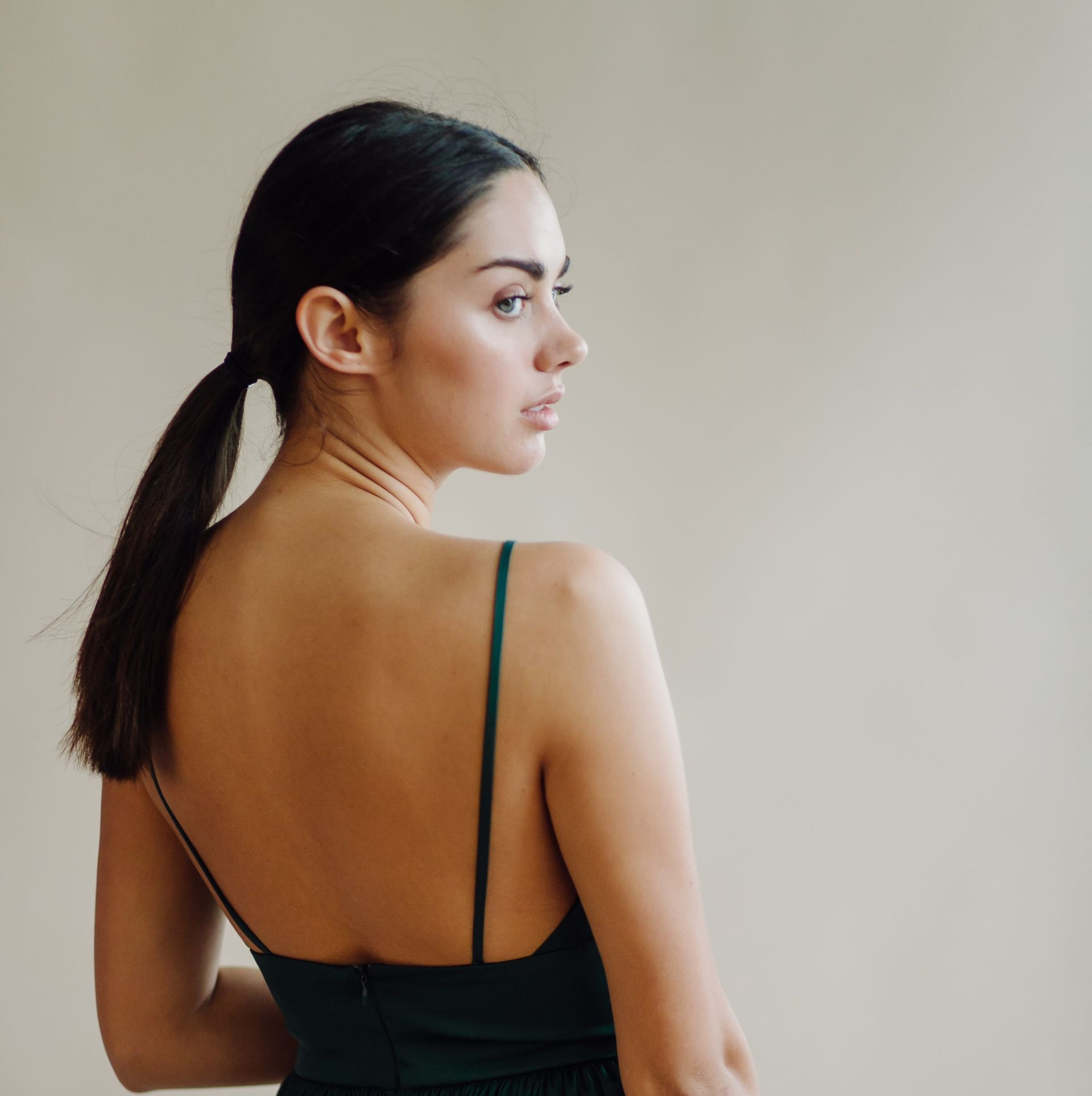 woman in a dress with her back towards the camera.