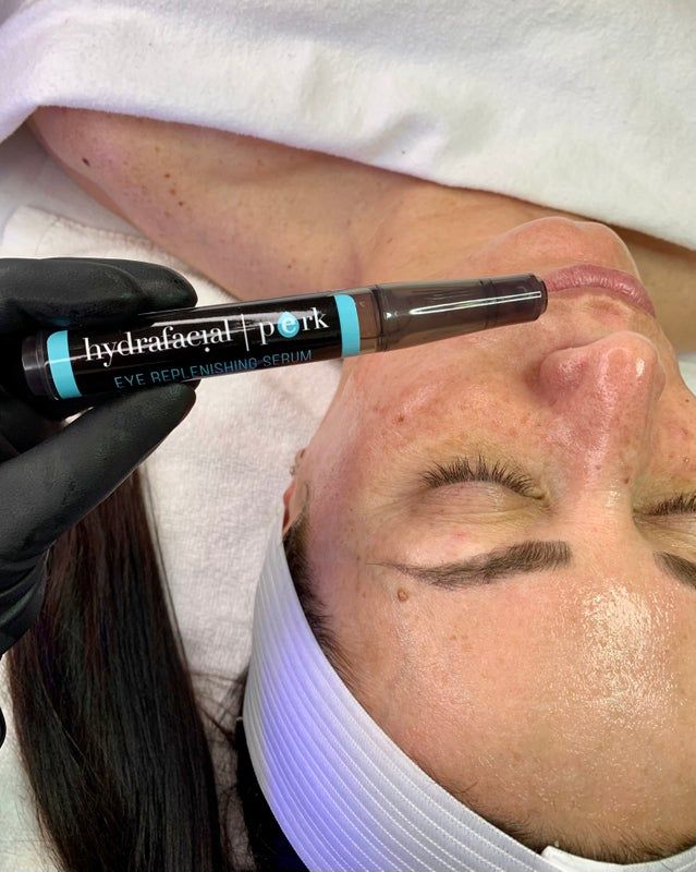 A woman is getting a facial treatment at a beauty salon.